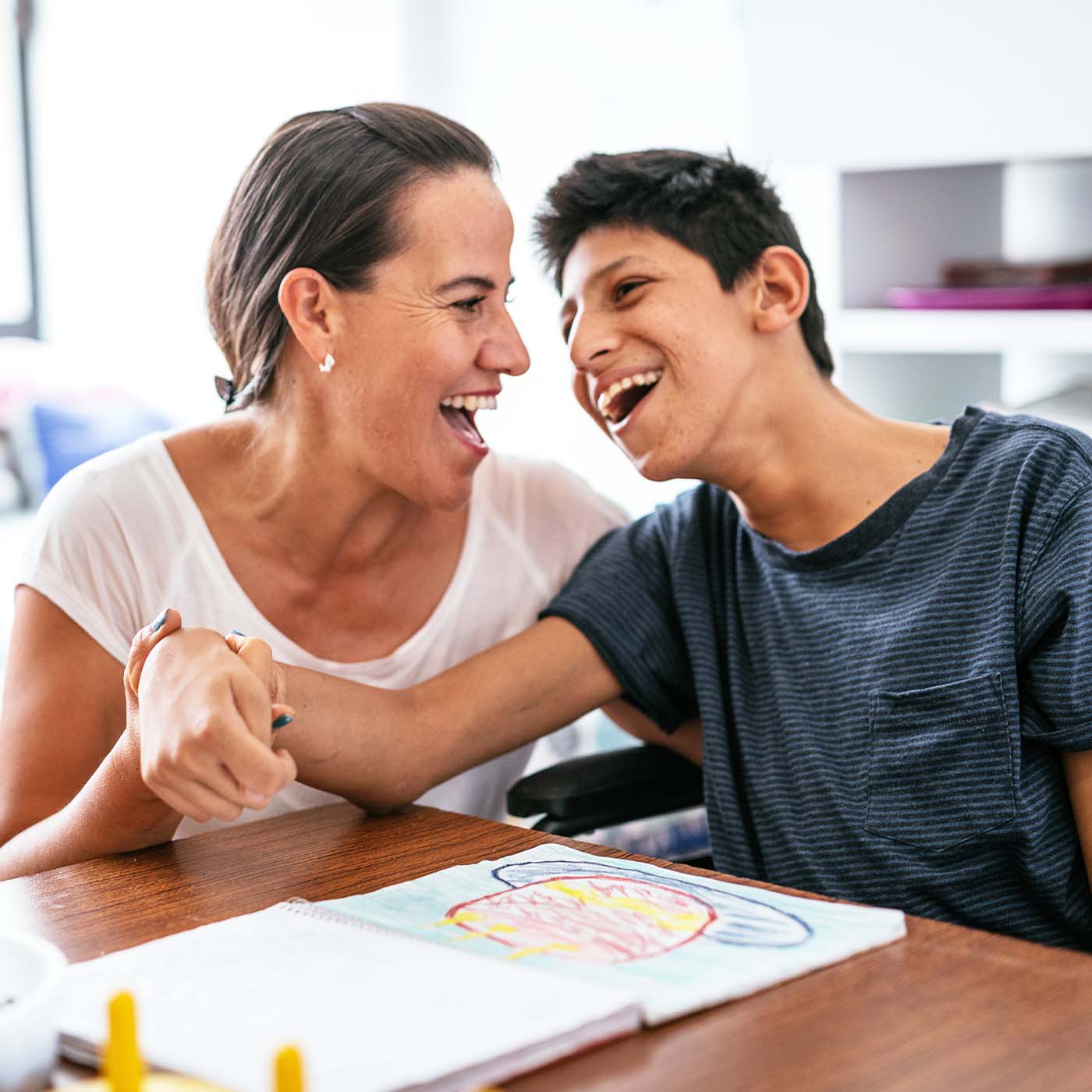 mom laughing with son who has intellectual disability-v2